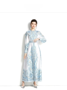 Detail of elegant paisley print maxi dress with stand collar and matching waist belt