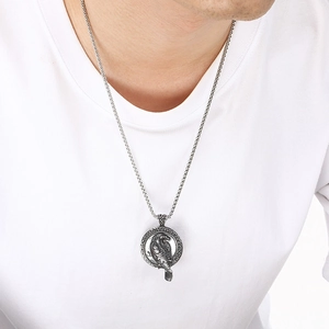 Viking raven pendant necklace in retro silver finish worn by male model on white background