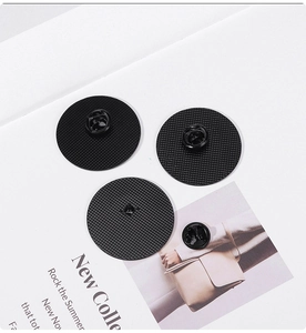 Detail view of black alloy brooch back with butterfly clutch and textured anti-slip grid