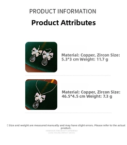 Detailed view of zircon bow earrings and necklace set with dark teardrop tassels