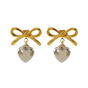 Elegant gold bow earrings with silver heart pendants on a clean white background