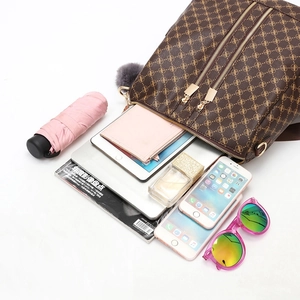 Classic brown monogram backpack with dual gold zippers and gray pompom for daily essentials