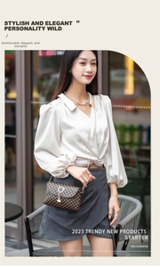 Detailed view of brown quilted bag with cat-ear metal buckle and pearl pendant detail