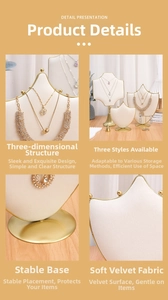 Close-up of velvet jewelry display stands with gold metal edges for necklaces and rings