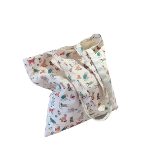 White canvas tote bag with colorful cartoon dog print and wide shoulder straps
