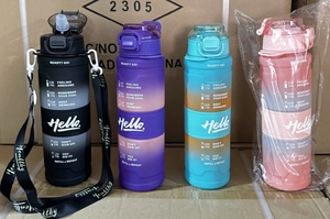 Detail showing gradient sports bottles in four colors with portable straps and time markers