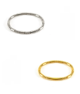 Detail of bamboo-style 18K gold and silver beaded bangles in lead-free stainless steel