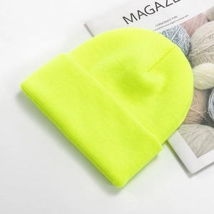 Detailed texture of fluorescent yellow ribbed knit beanie with a wide folded cuff edge