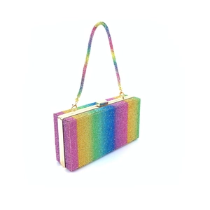 Detailed view of luxury clutch bag featuring rainbow rhinestones and golden metal hardware