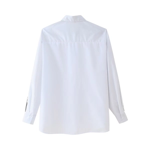 Rear view of a white long-sleeved shirt showing the back tailoring and clean fabric texture
