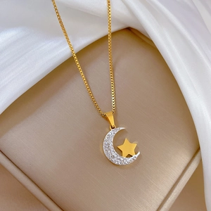 Minimalist gold titanium steel necklace with sparkling moon and star pendant on silk