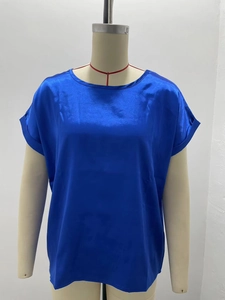 Close-up of royal blue satin short sleeve blouse with elegant crew neck and silky texture