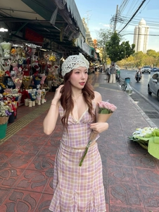 Detail of pink plaid backless top and ruffle skirt set with a crochet beret outdoors