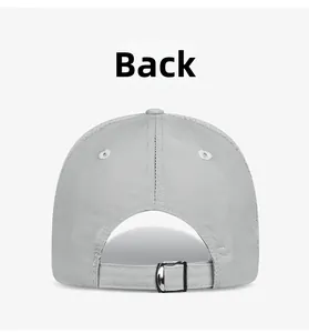Detail view of adjustable metal buckle and breathable mesh on a light grey sun cap