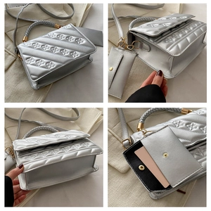Detail of silver crossbody bag with diamond stitching and braided handle detail