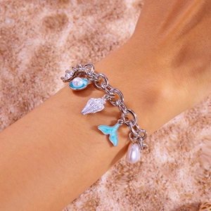 Close-up of ocean-themed necklace with starfish, shell, pearl and fish tail pendants