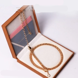 Minimalist gold corn chain decorative body chain presented in a stylish gift box