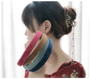 Detail of velvet headbands in multiple colors and butterfly clip with pearl tassels