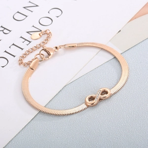 Macro shot of rose gold infinity charm bracelet with sparkling inlaid zircon stones