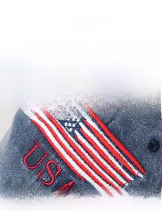 Detailed macro view of vintage USA embroidery and high-quality twill cotton fabric on navy cap