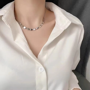 Minimalist silver LOVE cube stainless steel snake chain necklace worn by a fashion model