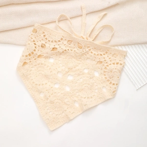 Close-up of beige crochet floral bandana showing intricate hollow mandala knit patterns