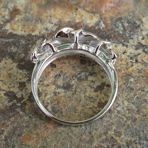 Macro detail of silver heart shaped flower ring with sparkling zircon stones