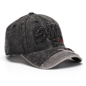 Detail of distressed denim baseball cap featuring SMILE embroidery and stay cool text