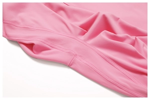 Detail of pink flare yoga pants showing flatlock stitching and soft matte fabric texture