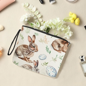 Easter egg canvas makeup bag with rabbit prints and zipper handle on textured background