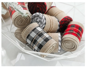 Close-up of assorted plaid and burlap ribbons in a basket for holiday gift wrapping