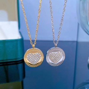 Close-up of gold and silver heart necklaces with crystal-encrusted round pendants