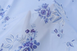 Nahaufnahme der halbtransparenten blauen Blumen-Mesh-Stoffstruktur mit feinem Druck