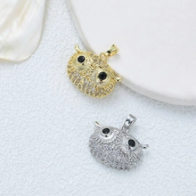 Detailed macro shot of gold and silver owl pendants with micro-pave zirconia crystals