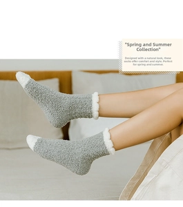 Detailed view of warm gray and white coral fleece mid-calf socks for winter sleep