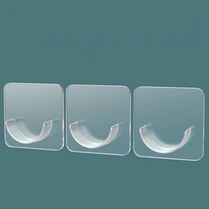 Three transparent adhesive wall hooks with U-shape design on a teal background