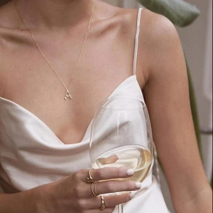 Elegant 18k gold letter A pendant necklace with matching gold rings for a stylish look