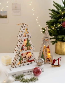 Close-up of wooden Christmas LED lantern with reindeer and tree cutout detail