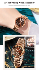 Close-up of rose gold watch with brown sunburst dial and crystal markers on marble