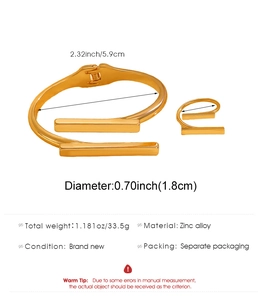 Macro view of geometric gold bangle and ring set showing size and zinc alloy material