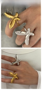 Detail view of butterfly rings in gold and silver finish with organic 3D design
