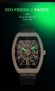 Macro shot of luminous green watch hands and markers on rose gold tonneau dial