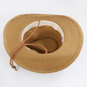Detail of western straw hat interior with white sweatband and adjustable chin strap