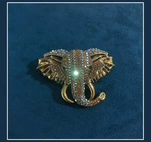 Detail of vintage elephant brooch with gold plating and colorful sparkling rhinestones
