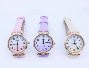 Detailed view of three quartz watches with gradient dials and shimmering leather straps