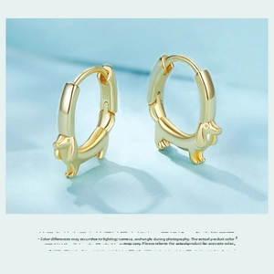 Close-up of S925 sterling silver dachshund dog hoop earrings with detailed golden finish