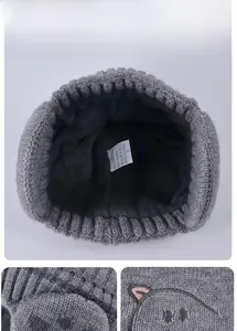 Detail of kids knit hat showing soft grey fleece lining and material composition label