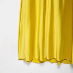 Elegant yellow satin midi dress featuring a smooth silk texture and fine hemline detail