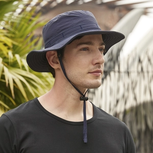 Close-up of navy blue outdoor bucket hat with adjustable chin strap and wide brim