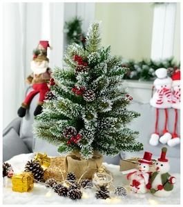 Detailed view of a 60cm mini Christmas tree with snow, berries, cones, and burlap base